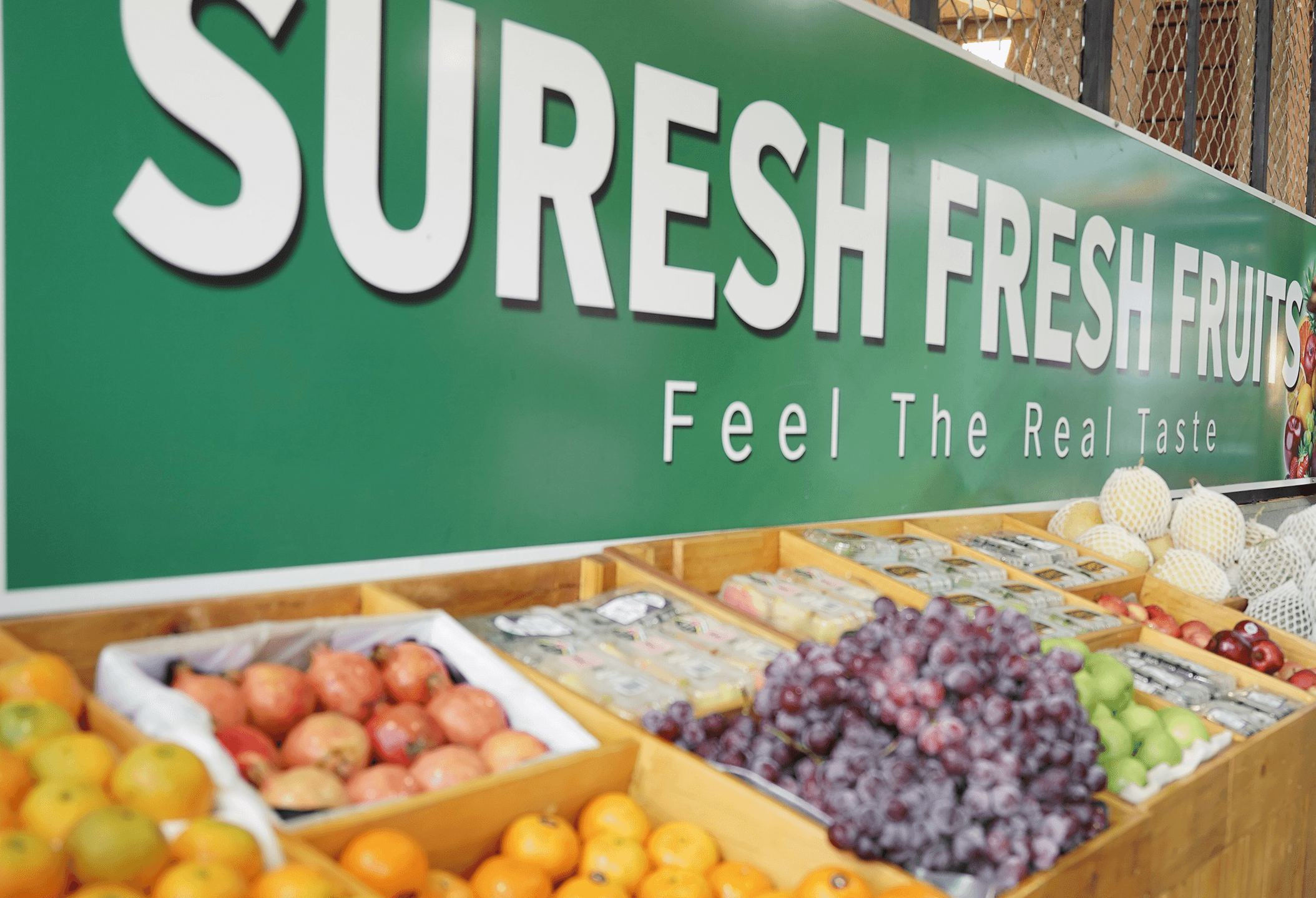 Suresh Fresh Fruits stall with fresh grapes, apples and citrus under the brand banner