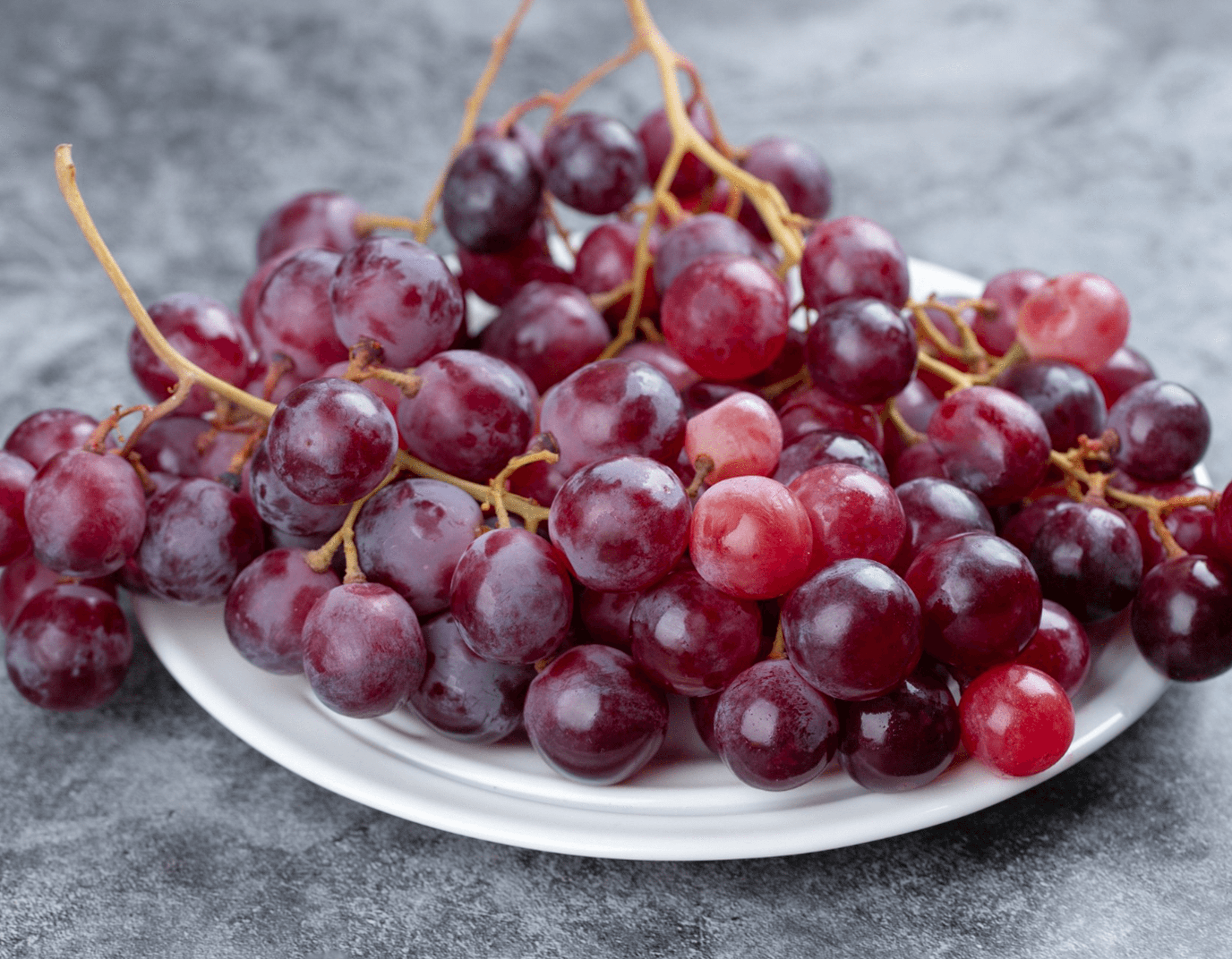 Fresh red grapes arranged on a plate for hospitality supply